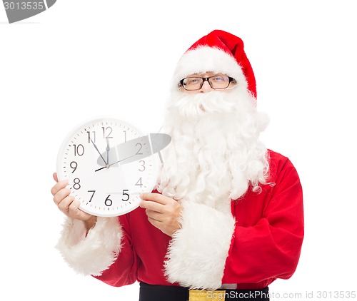 Image of man in costume of santa claus with clock