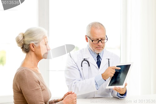 Image of senior woman and doctor with tablet pc