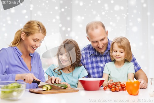 Image of happy family with two kids making dinner at home