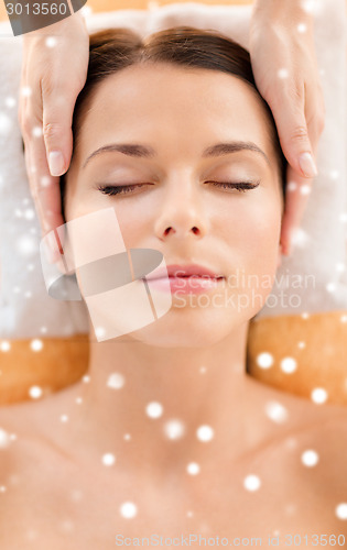 Image of beautiful woman getting face or head massage