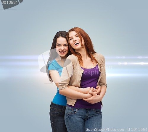 Image of smiling teenage girls hugging