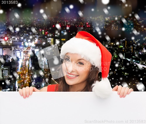 Image of woman in santa helper hat with blank white board