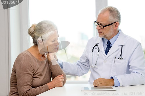 Image of senior woman and doctor with tablet pc