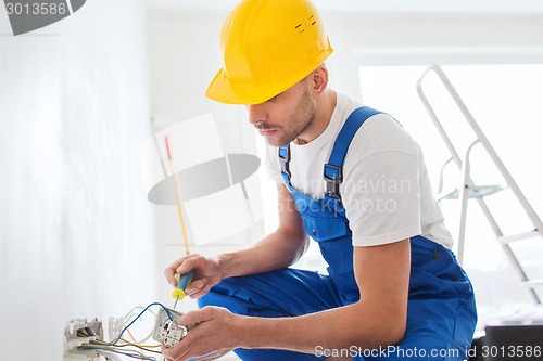 Image of builder with tablet pc and equipment indoors