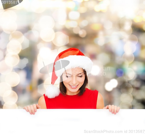 Image of woman in santa helper hat with blank white board