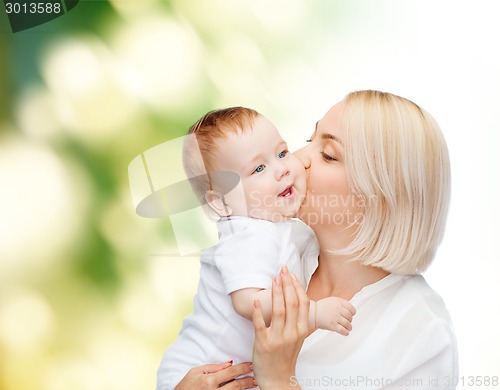 Image of happy mother kissing smiling baby