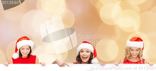 Image of women in santa helper hat with blank white board
