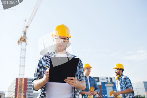 Image of group of builders in hardhats outdoors