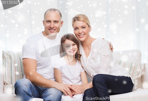 Image of smiling parents and little girl at home