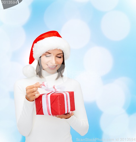 Image of smiling woman in santa helper hat with gift box