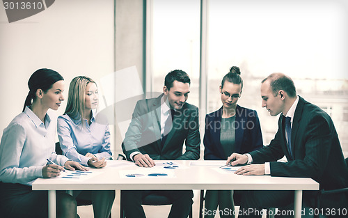 Image of business team with documents having discussion