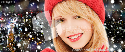 Image of close up of smiling young woman in winter clothes