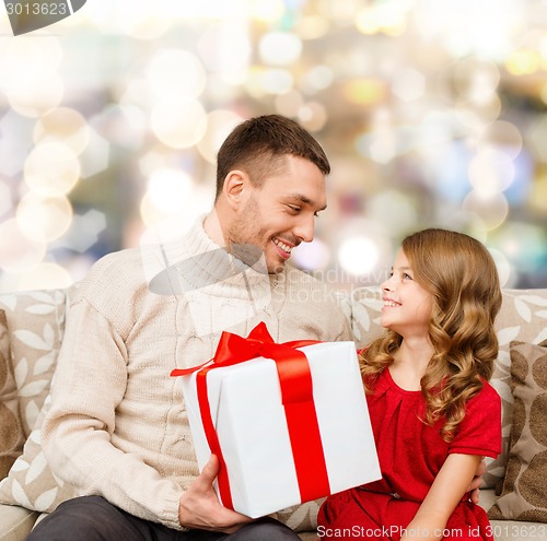 Image of smiling father and daughter with gift box