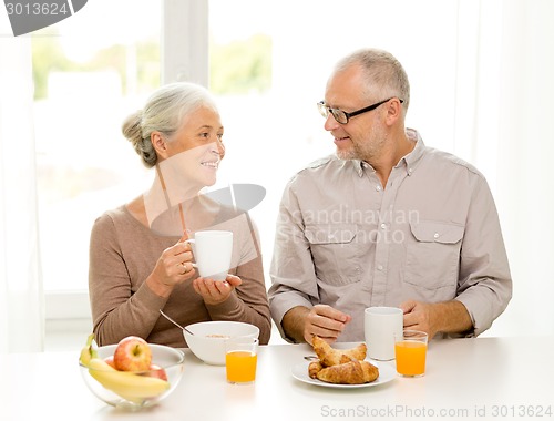 Image of happy senior couple having breakfast at home