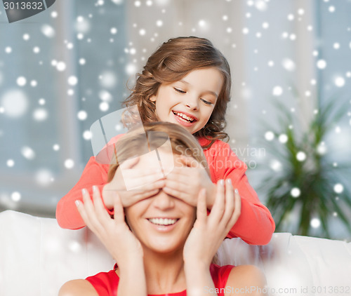 Image of happy mother and daughter having fun at home