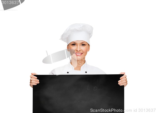 Image of smiling female chef with white blank board