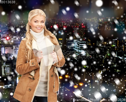 Image of smiling young woman in winter clothes