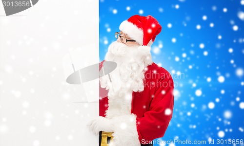 Image of man in costume of santa claus with billboard