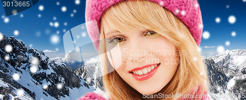 Image of close up of smiling young woman in winter clothes