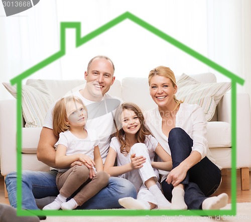 Image of smiling parents and two little girls at new home