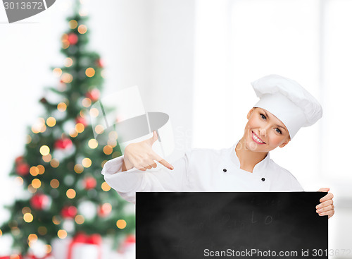 Image of smiling female chef with white blank board