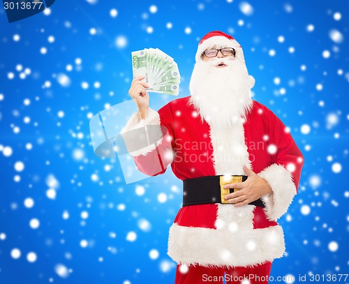 Image of man in costume of santa claus with euro money