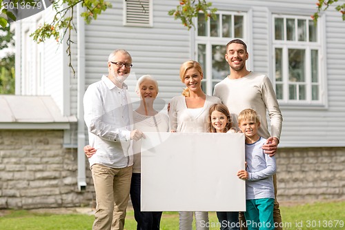 Image of happy family in front of house outdoors