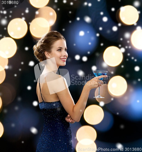 Image of smiling woman holding cocktail