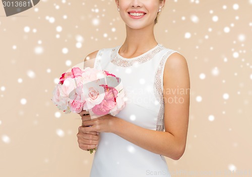 Image of close up of woman in white dress with flowers