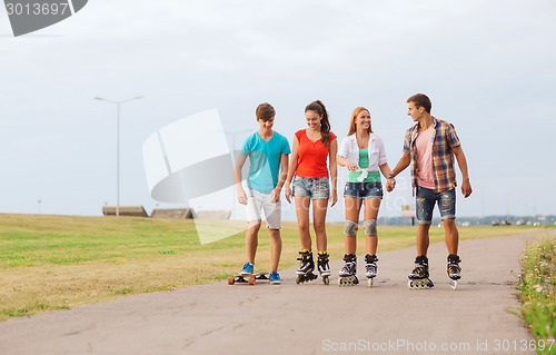 Image of group of smiling teenagers with roller-skates