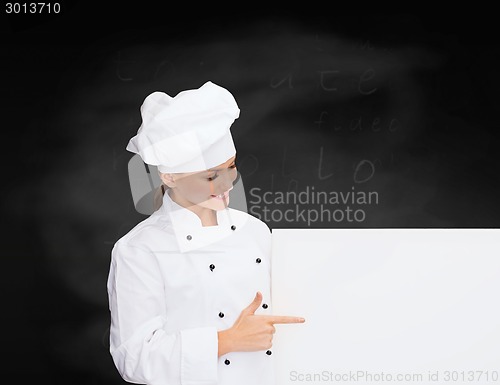 Image of smiling female chef with white blank board