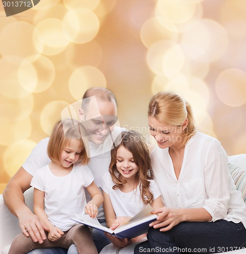 Image of happy family with book at home