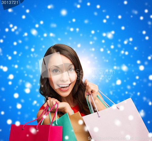 Image of smiling woman with colorful shopping bags