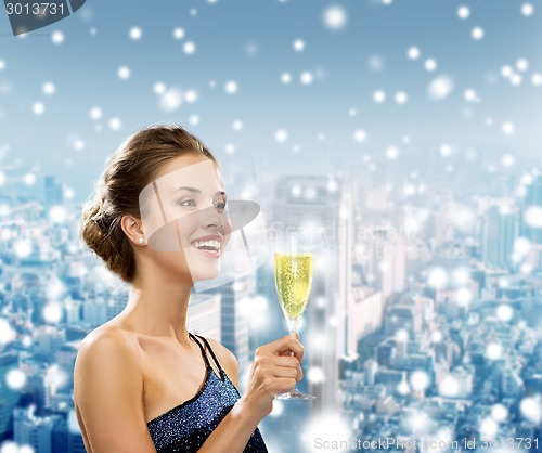 Image of smiling woman holding glass of sparkling wine