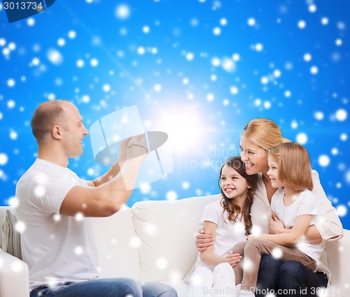 Image of happy family with camera at home