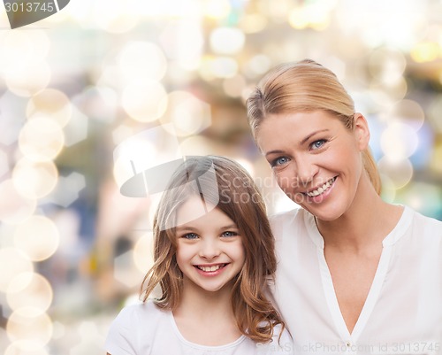 Image of smiling mother and little girl