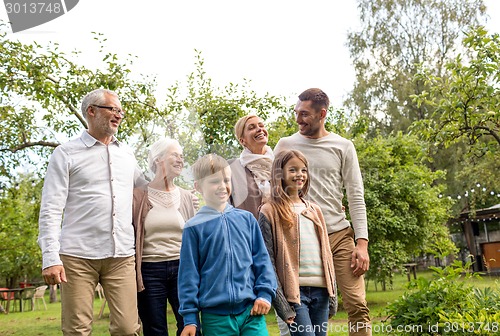 Image of happy family in front of house outdoors