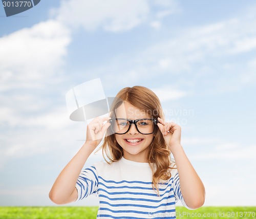 Image of smiling cute little girl with black eyeglasses