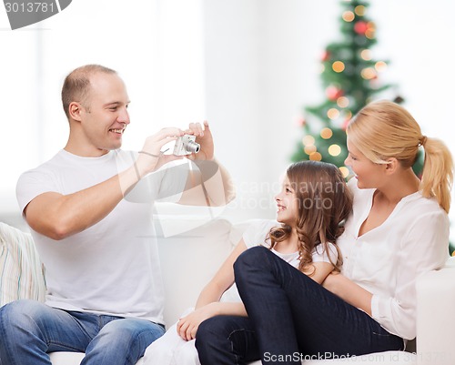 Image of happy family with camera at home