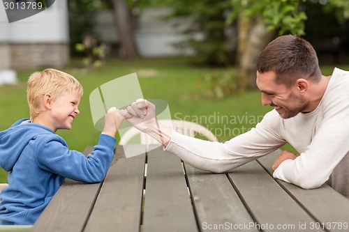 Image of happy family in front of house outdoors