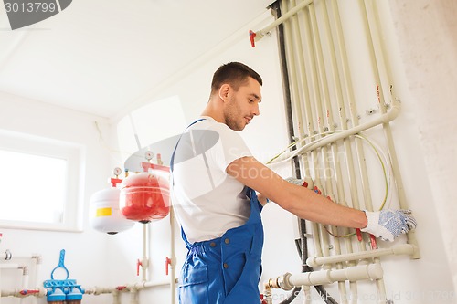 Image of builder or plumber working indoors