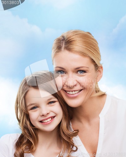 Image of smiling mother and little girl