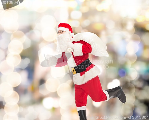 Image of man in costume of santa claus with bag