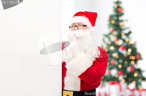 Image of man in costume of santa claus with billboard