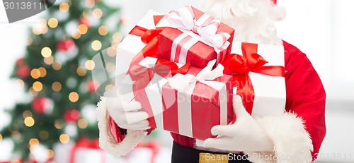 Image of man in costume of santa claus with gift box