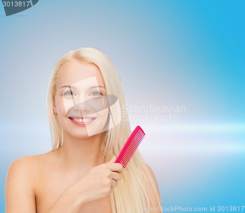 Image of smiling woman with hair brush