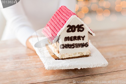 Image of close up of woman showing gingerbread house