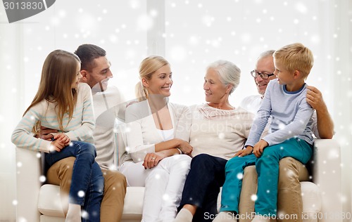 Image of happy family sitting on couch at home