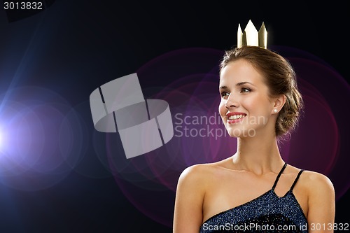 Image of smiling woman in evening dress wearing crown