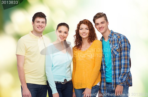 Image of group of smiling teenagers over green background